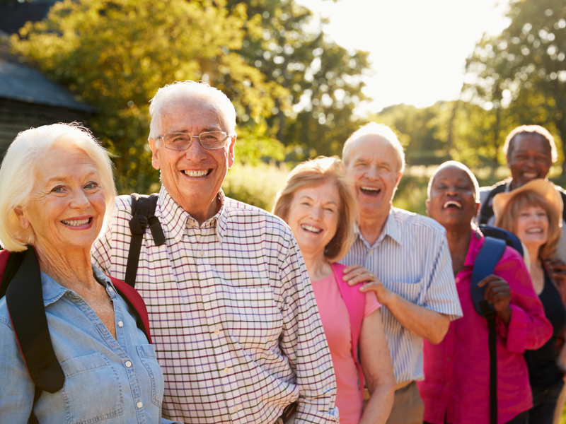 Portrait Of Senior Friends Hiking In Countryside